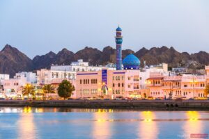 Oman, Muscat. Cityscape of Mutrah harbour, at dusk